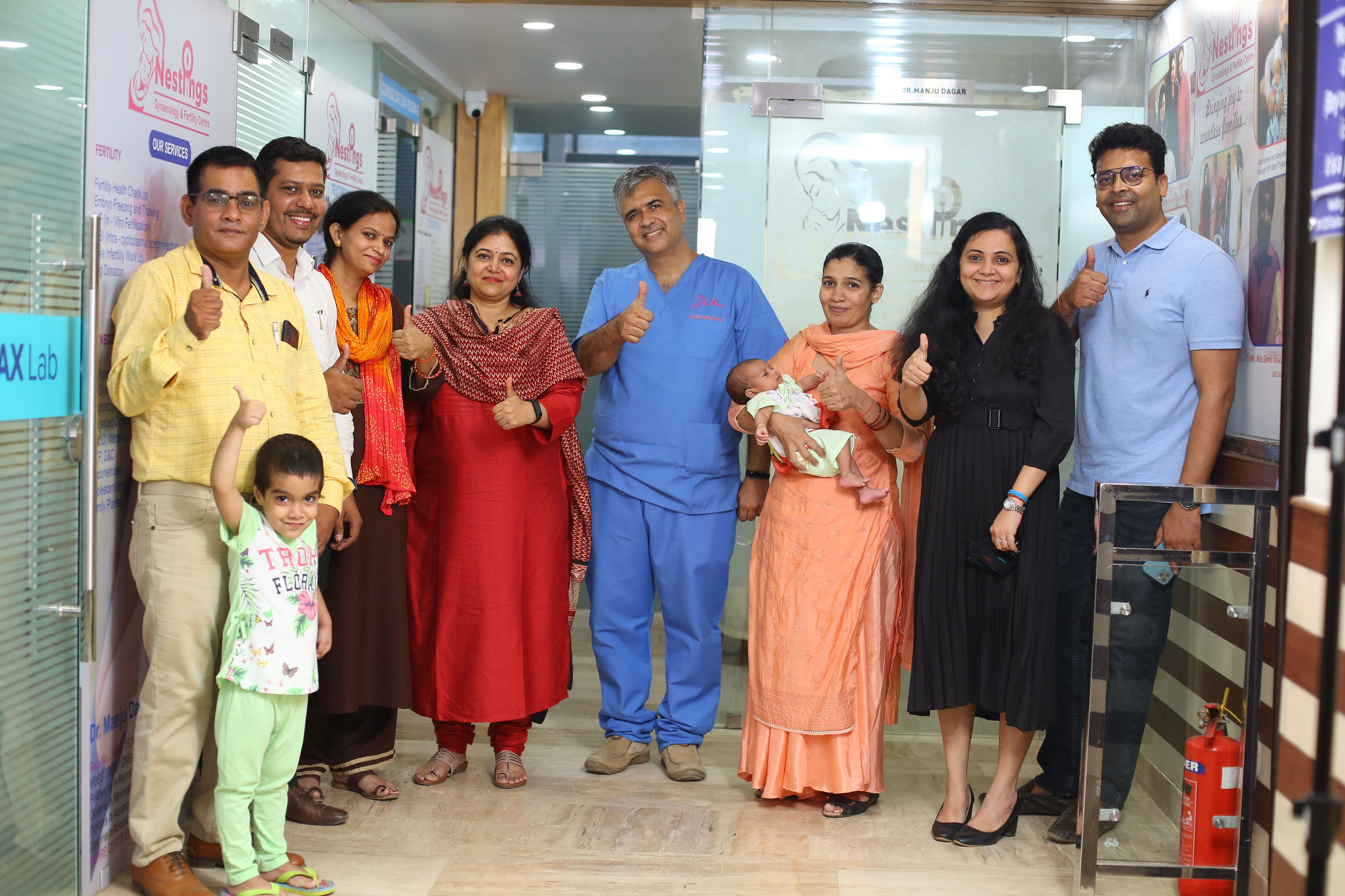 Indian family holding newborn baby in clinic